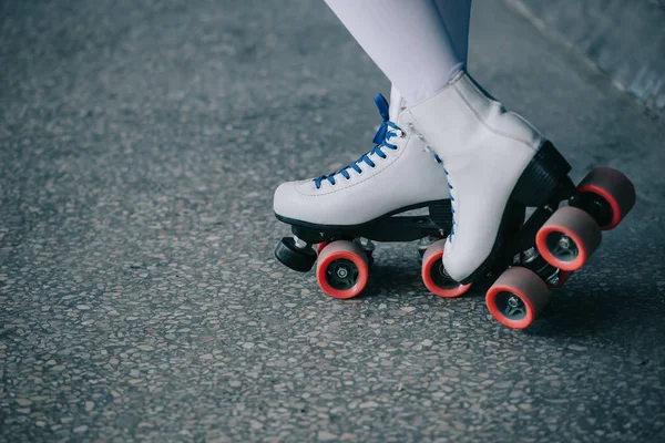 Partial view of woman in white high socks and retro roller skates — Stock Photo