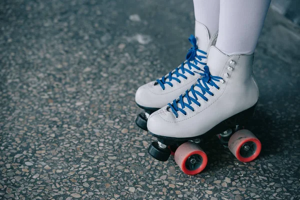 Partial view of woman in white high socks and retro roller skates — Stock Photo