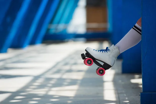 Cropped shot of female leg in vintage roller skate on street — Stock Photo