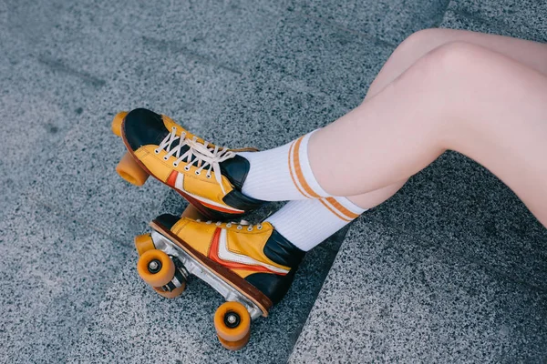 Close-up partial view of female legs in roller skates on stairs — Stock Photo