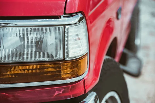 Close up of of headlight of red jeep — Stock Photo