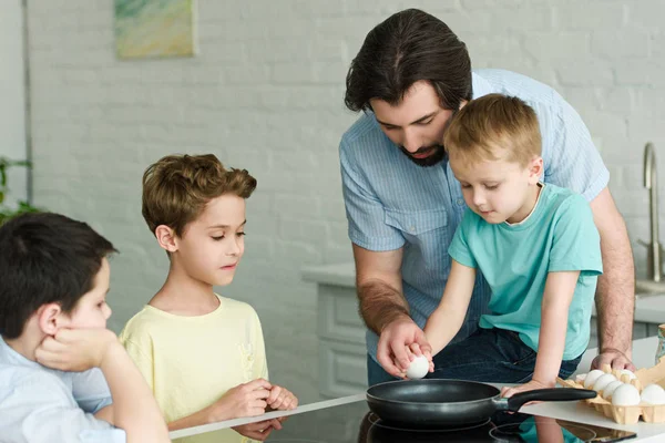 Portrait of family cooking breakfast together in kitchen at home — Stock Photo