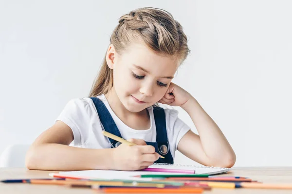 Beautiful little child drawing with color pencils isolated on white — Stock Photo