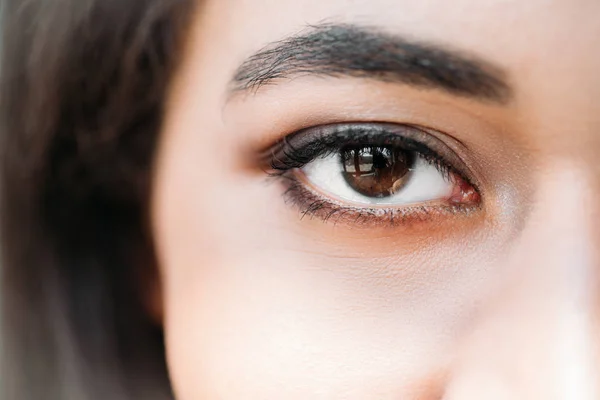 Close up shot of eye of mixed race woman — Stock Photo