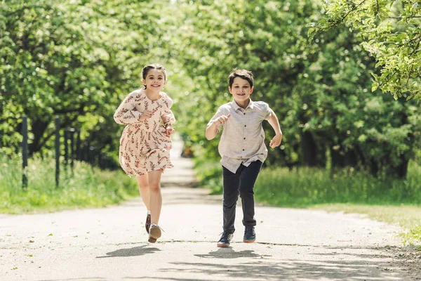Happy kids having fun and running in summer park — Stock Photo