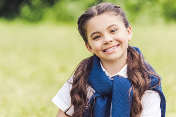 Close-up portrait of beautiful schoolgirl in stylish clothes in park — Stock Photo