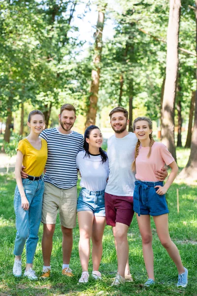 Happy friends hugging together in park — Stock Photo