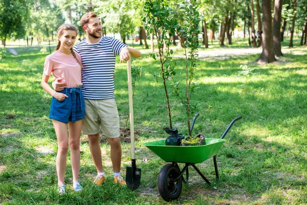 Couple câlin tout en faisant du bénévolat dans le parc — Photo de stock