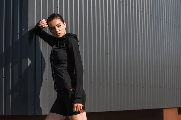Young sportswoman posing in black thermal clothes — Stock Photo