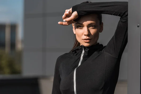 Portrait of sportswoman posing in black thermal clothes — Stock Photo