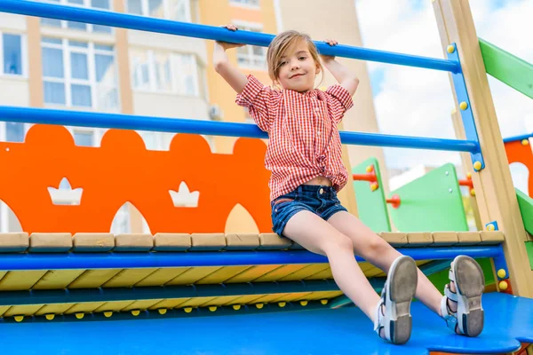 Selektiver Fokus des lächelnden kleinen Kindes, das Spaß auf dem Spielplatz hat — Stockfoto