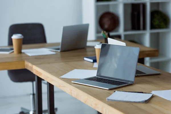 Laptops e café em copos de papel na mesa no escritório de arranque — Fotografia de Stock