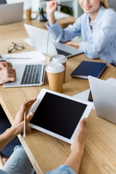 Cropped image of colleagues working on startup project in office with tablet with blank screen — Stock Photo