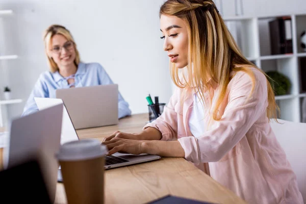 Multicultural colleagues working on startup project in office with laptops — Stock Photo