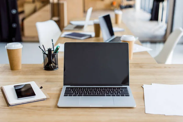 Laptops and smartphone on tables in business office — Stock Photo