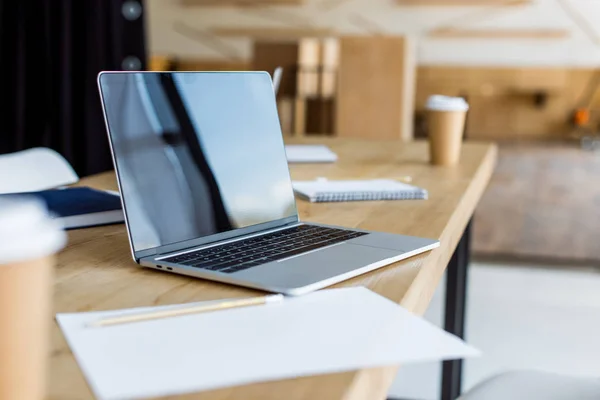 Laptop on wooden table in business office — Stock Photo