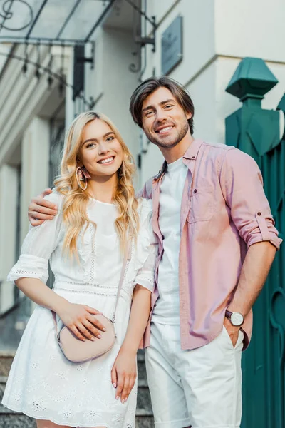 Portrait of happy couple standing on city street — Stock Photo