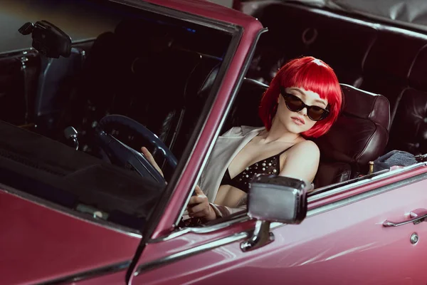 High angle view of beautiful girl in bra and sunglasses driving vintage car — Stock Photo
