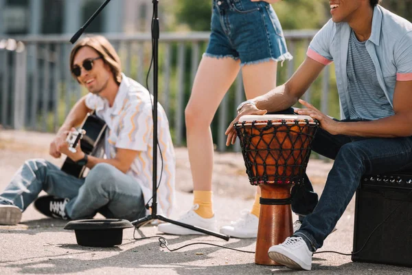 Young happy buskers performing and singing at city street — Stock Photo