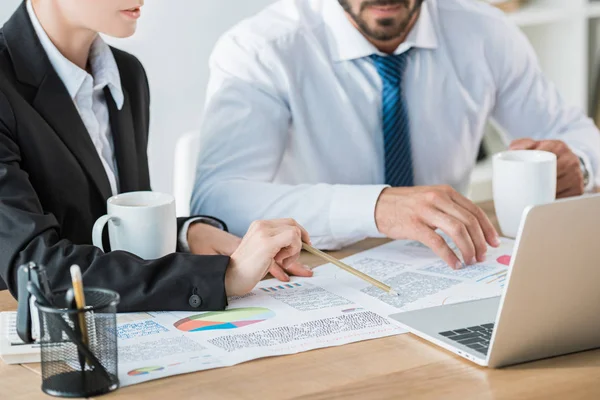 Cropped image of accountants working during coffee break in office — Stock Photo