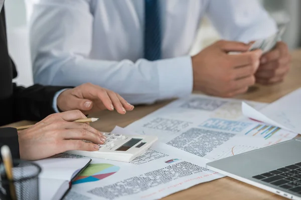 Imagen recortada de los financistas contando dinero juntos en la oficina - foto de stock