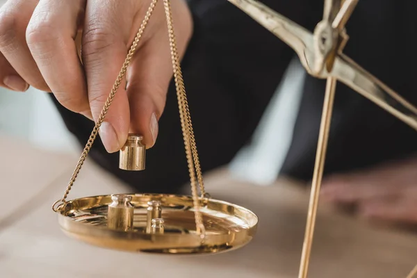 Cropped image of accountant putting precision weights on scales in office — Stock Photo