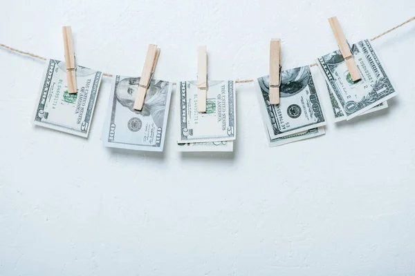 Dollar banknotes hanging on rope isolated on grey — Stock Photo