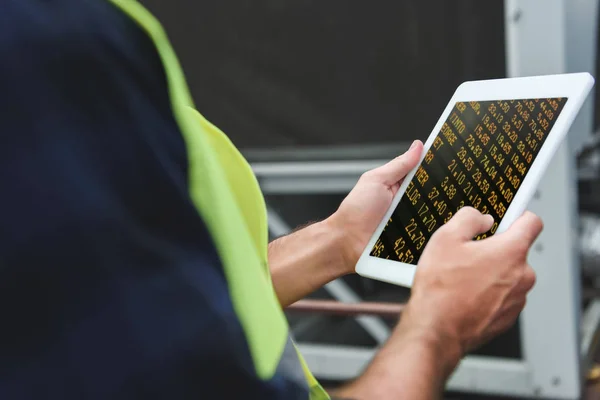 Cropped view of worker using digital tablet with numbers — Stock Photo