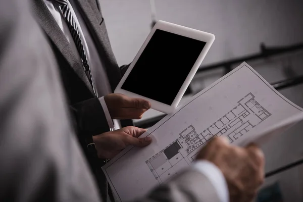 Cropped view of businessmen with blueprint and digital tablet with blank screen — Stock Photo