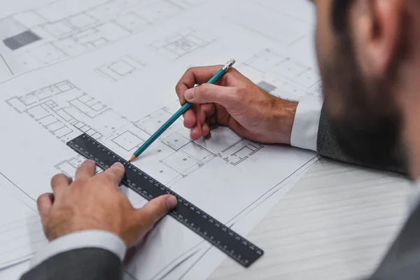 Cropped view of architect working with blueprints, pencil and ruler — Stock Photo