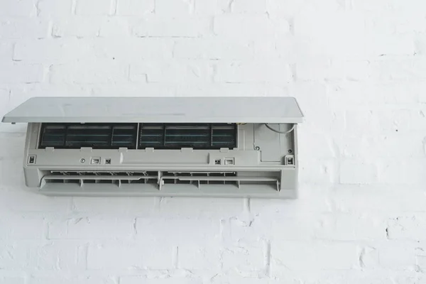 Opened air conditioner on white wall at home — Stock Photo