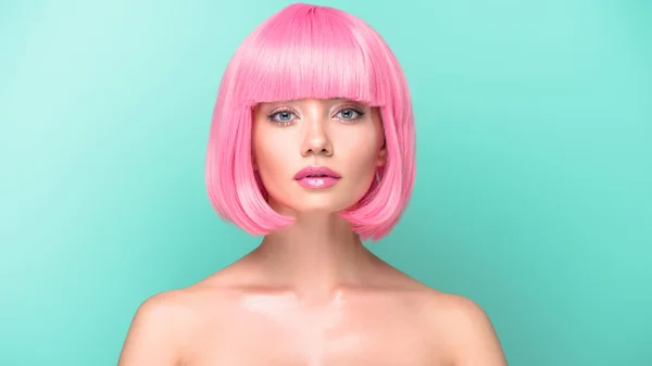 Confident young woman with pink bob cut looking at camera isolated on turquoise — Stock Photo