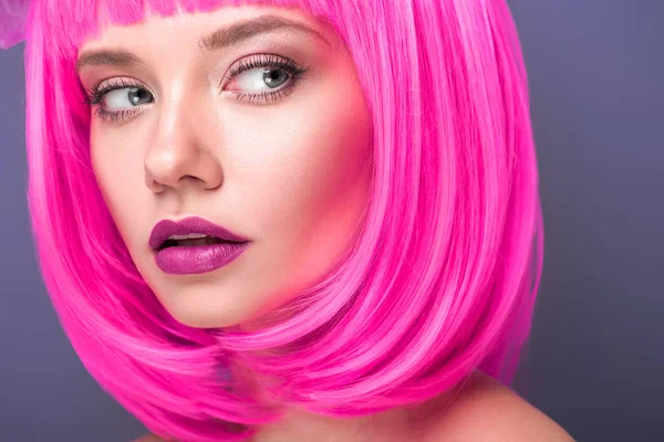 Beautiful young woman with pink bob cut isolated on violet — Stock Photo