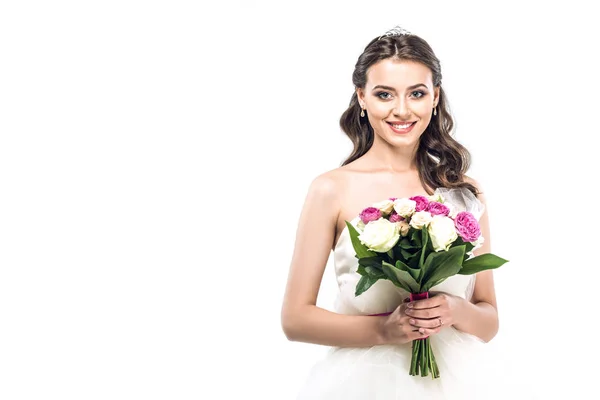 Close-up portrait of young bride in wedding dress with earrings and tiara holding bouquet isolated on white — Stock Photo