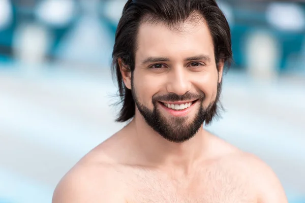 Portrait of handsome bearded shirtless man smiling at camera — Stock Photo
