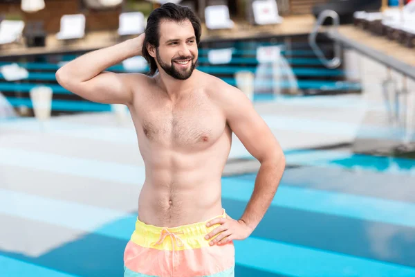 Handsome bearded man posing near swimming pool — Stock Photo