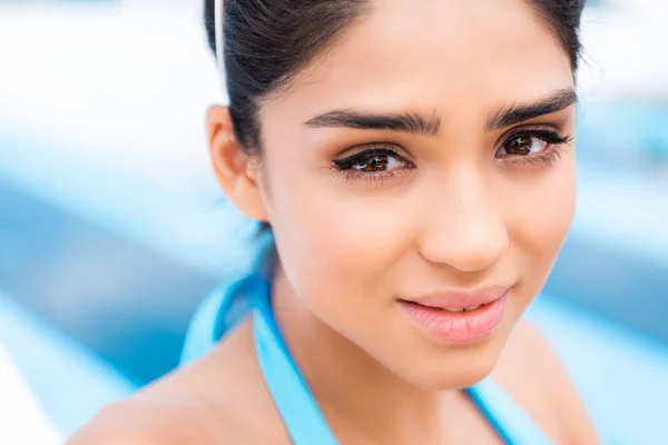 Portrait of attractive tanned young woman looking at camera — Stock Photo