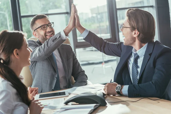 Happy business people giving high five during meeting at modern office — Stock Photo