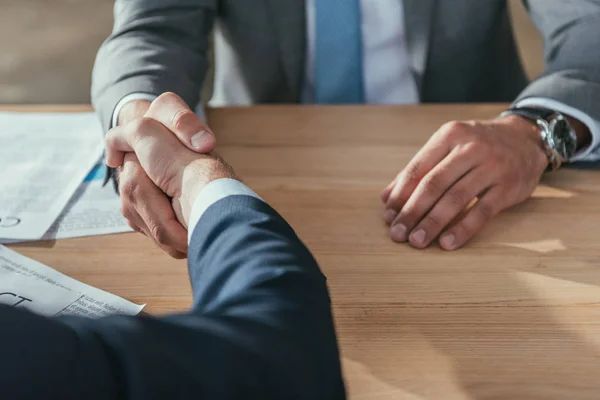 Cropped shot of business partners shaking hands — Stock Photo