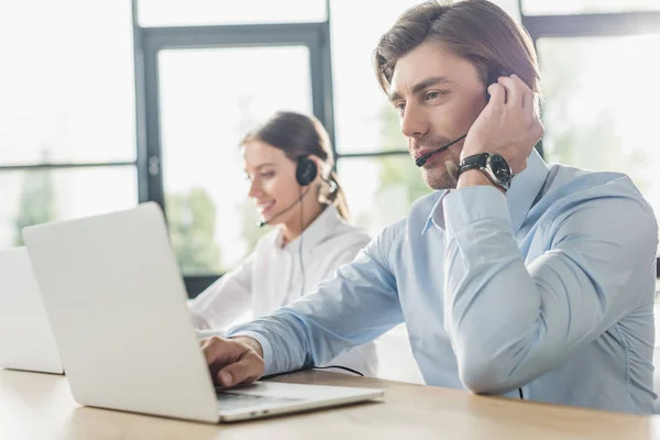 Male and female call center managers working together at modern office — Stock Photo