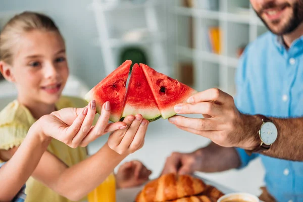 Cropped shot of family clinking pieces of watermelon — Stock Photo
