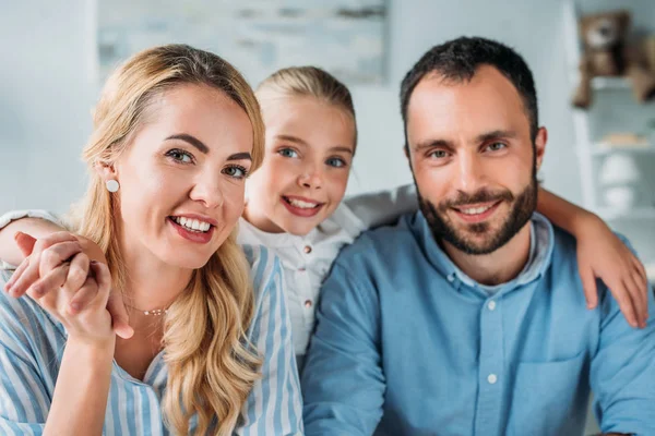 Happy young family looking at camera — Stock Photo