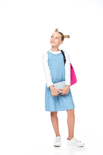 Cheerful schoolchild holding books and looking up isolated on white — Stock Photo