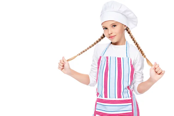 Schoolchild in costume of chef holding braids isolated on white — Stock Photo