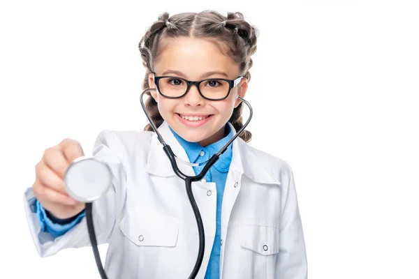 Schoolchild in costume of doctor examining with stethoscope isolated on white — Stock Photo