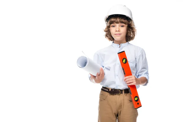 Schoolboy in costume of architect and helmet holding blueprints and spirit level isolated on white — Stock Photo