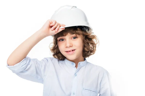 Écolier en costume d'architecte toucher casque isolé sur blanc — Photo de stock