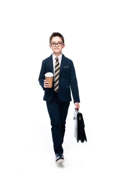 Schoolboy in businessman suit walking with coffee to go and bag isolated on white — Stock Photo