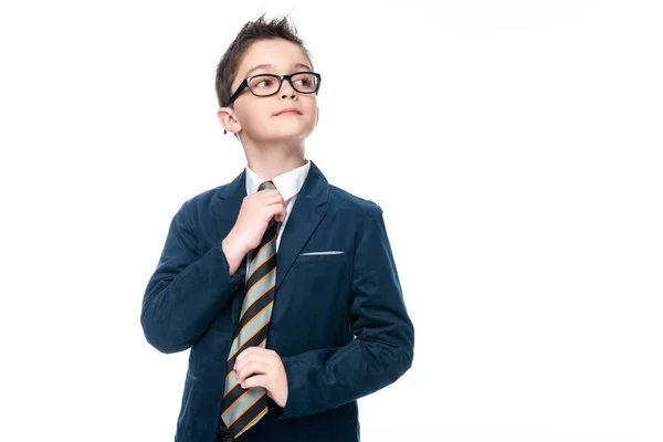Schoolboy in businessman suit tying necktie isolated on white — Stock Photo