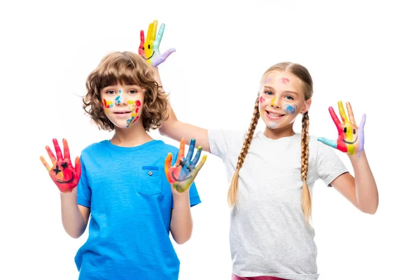 Two classmates having fun and showing painted hands with smiley icons isolated on white — Stock Photo